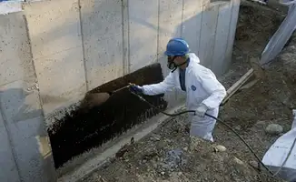 Professional waterproofing the exterior walls of the basement in Birmingham, AL