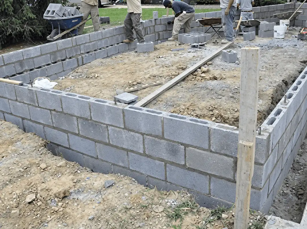 Professionals building a foundation with blocks in Birmingham, AL
